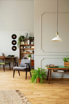 a living room filled with furniture next to a wooden table and green plant in a pot