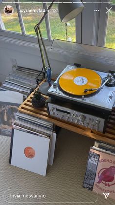 a record player sitting on top of a wooden table