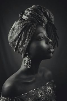 an african woman with braids and earrings on her head, in black and white