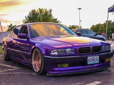 a purple car is parked in a parking lot