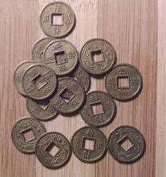 some chinese coins are sitting on a table and there is no image here to provide a caption for