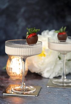 two glasses filled with chocolate covered strawberries