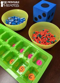 three bowls with numbers and dices in them sitting on a table next to each other