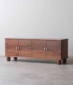 the sideboard is made out of wood and has two brass pulls on each side