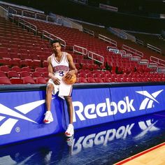 a basketball player sitting on the bench with his ball