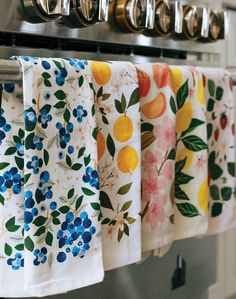 colorful kitchen towels hanging on an oven rack