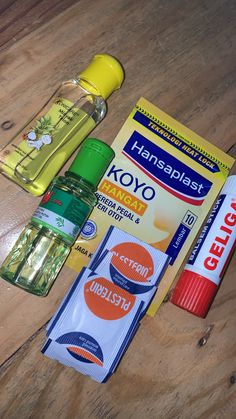 the contents of a toothbrush, mouthpaste, and other items are laid out on a wooden surface