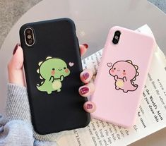 two phone cases with cartoon animals on them, one is pink and the other is black