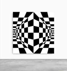 a black and white abstract art piece hanging on the wall in an empty room with concrete flooring