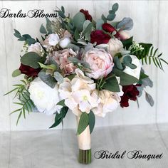 a bridal bouquet with white and red flowers