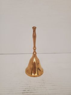 a gold vase sitting on top of a white table