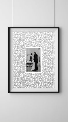 a black and white photo hanging on the wall next to a frame with words all over it