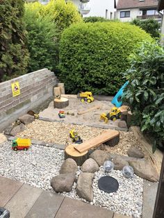 a backyard area with rocks, gravel and construction equipment