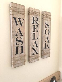 three wooden signs are hanging on the wall