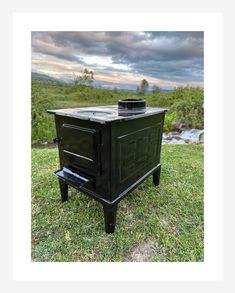 an outdoor wood burning stove in the grass