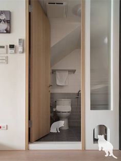 a bathroom with a cat figurine on the floor