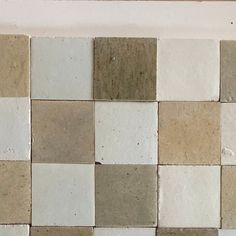 a white and brown checkered tile wall