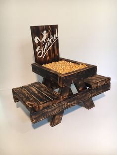 a wooden stand with corn in it and a sign that says superbful on the side