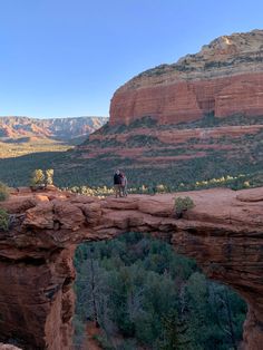 a person standing on top of a cliff