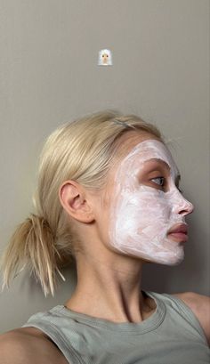 a woman with a white mask on her face and one half of her face is visible