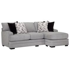 a gray sectional couch with black pillows and throw pillows on the bottom half of it