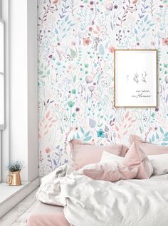 a bedroom with floral wallpaper and pink bedding