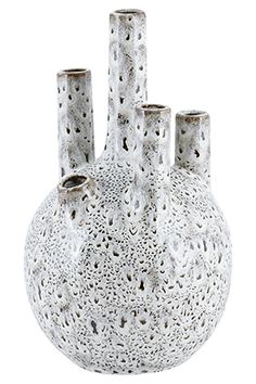 three white vases with holes in them sitting side by side on a white background