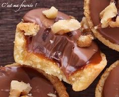 some chocolate covered cookies with nuts on top