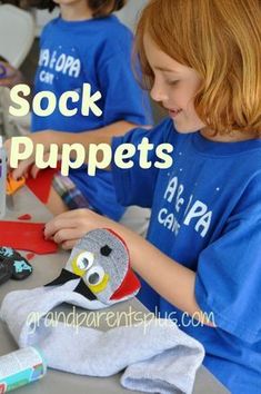 two children are making sock puppets at a table