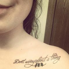 a woman with a tattoo on her chest saying don't worry about a thing