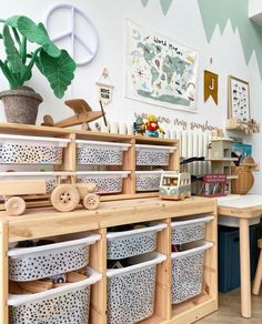 a room filled with lots of different types of baskets and wooden toys on top of shelves