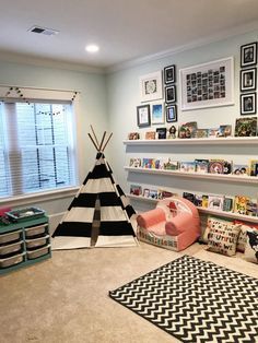 a child's playroom with teepee tent, bookshelf and toys