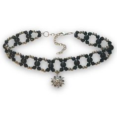 a black beaded necklace with a silver cross charm