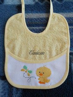 an embroidered bib with a duck on it