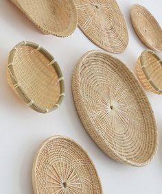 wicker baskets are arranged on a white surface