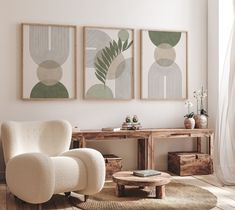 three paintings hang on the wall above a chair and coffee table in a living room