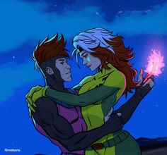 a man and woman hugging each other with fire in their hands on a night sky background