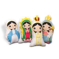 three pillows with dolls on them sitting next to each other in front of a white background