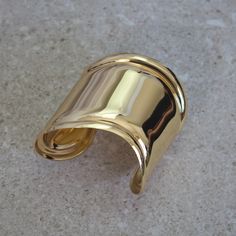 a close up of a gold colored object on a surface with no one around it