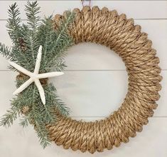 a rope wreath with starfish and evergreen branches