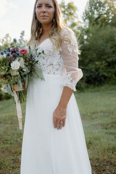 a woman in a white dress holding a bouquet