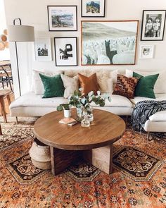 a living room filled with furniture and pictures on the wall