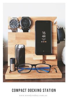 a wooden docking station with glasses, watch and cell phone