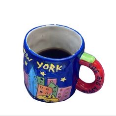 a blue mug with new york on it and the words new york painted on it