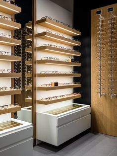 a pair of glasses are on display in a store with wooden shelves and eyeglasses