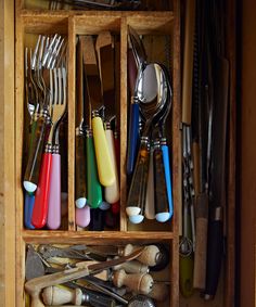 a wooden box filled with lots of different types of utensils