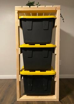 three plastic storage bins stacked on top of each other in front of a wall