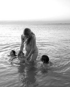 three women in the water playing with each other