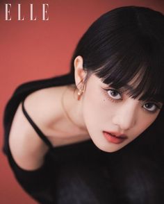 a woman with black hair and piercings posing for the camera