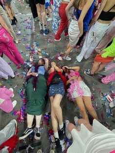 two women laying on the ground surrounded by confetti